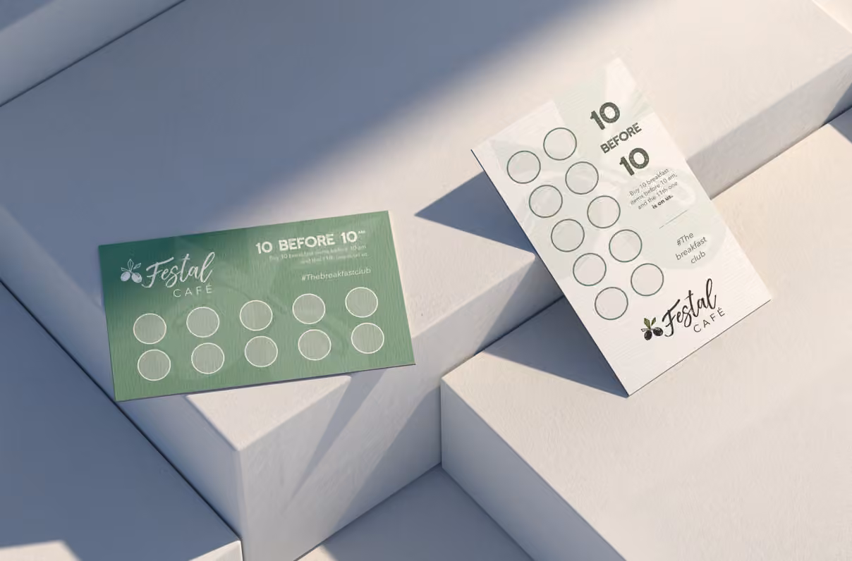 Green and white Festal Café 10 Before 10 loyalty cards arranged on geometric white blocks
