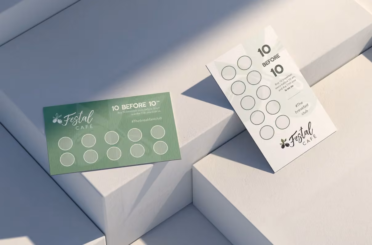 White and sage Festal Café loyalty cards on geometric display blocks