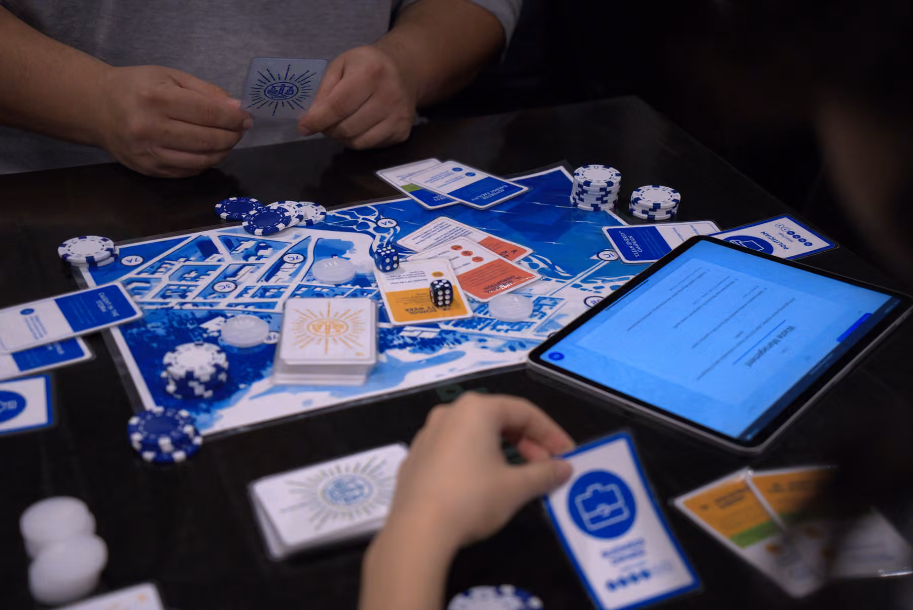Players using the physical game board and tablet companion together